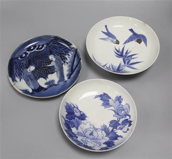 Three Nabeshima style blue and white dishes, figural dish diameter 21cm